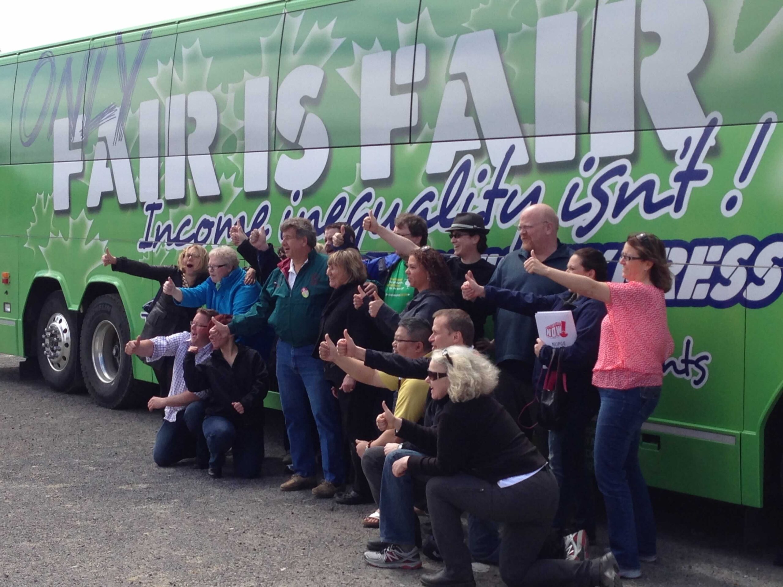 OPSEU members posing in front of a bus that says: Only fair is fair!