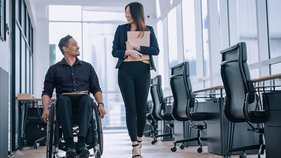 Worker in wheelchair having a conversation with a colleague